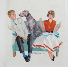 a man and woman sitting on a couch next to a dog