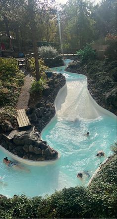 several people are swimming in the water slide