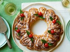 a bundt cake with icing and cherry tomatoes