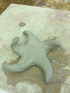 a piece of clay sitting on top of a wooden table