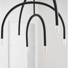 a black chandelier with five lights hanging from it