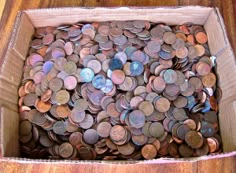 a cardboard box filled with lots of coins