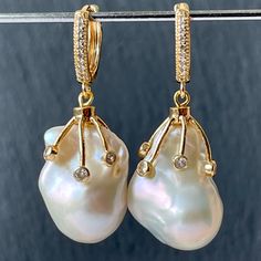 Excellent quality large white baroque teardrop pearls which I have dangled from CZ pave diamond huggie hoops and the most divine CZ tentacle hoops to make a gorgeous white statement pair of earrings for women! These aaa grade freshwater pearl jewelry would make a stunning gift for a bride, your daughter or your wife on her wedding day 100% natural untreated pearls Length of earrings from top to bottom is 1.5 inches Materials used: Size of large baroque pearls is 22mm X 16mm 18k gold plated huggi White Statement Earrings, Statement Earrings Wedding, Pearl Earrings Gold, Freshwater Pearl Jewelry, Wedding Gifts For Bride, Baroque Pearl Earrings, Jewelry White, Gold Pearl Earrings, Earrings Wedding