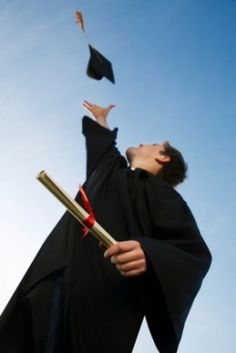 a graduate tossing his cap in the air