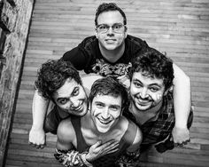 three men are posing for the camera with their faces painted like they're laughing