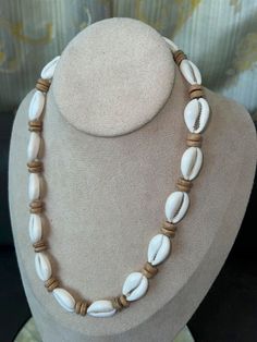 "This Native Treasure Authentic Tropical  Jewelry Cowrie Shell Necklace is Beautifully Hand-Crafted in our Tropical Jewelry Shop by our own Native Island Artisans using up to  1\" Long Hand-Selected Super  Class 'A' Quality Cowrie Shells.  Select your size from 14\" to 24\" inch length, priced accordingly. 8mm (5/16\") Real wood Coco Beads and  'Good Karma' Cowrie Shells Indigenous to  the Powder White Beaches of the Philippines. Perfect to take that Tropical Feeling with You! Truly Native Treas White Beach Jewelry With Wooden Beads, White Wooden Beads Jewelry For Beach, White Wooden Beads Jewelry For The Beach, White Wooden Beads Necklace For Vacation, Cowrie Shell Jewelry Necklaces, Wood Bead Jewelry, Cowrie Necklace, Afro Jewelry, Wood Beads Jewelry