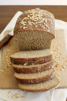 sliced loaf of bread sitting on top of a cutting board