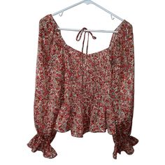 Add Some Bohemian Flair To Your Wardrobe With This Lucy Paris Blouse. The Multicolor Floral Pattern Adds A Pop Of Color To Any Outfit, While The Boat Neckline And Tie In The Back Give It A Unique And Feminine Touch. The Classic Fit And Long Sleeves Make It Perfect For Any Occasion, And It's Machine Washable For Easy Care. This Blouse Is Brand New With Tags And Made From 100% Polyester, Ensuring Quality And Durability. 100% Polyester Fall Vacation Blouse With Smocked Bodice, Red Long-sleeve Peasant Top For Spring, Red Long Sleeve Peasant Top With Floral Print, Long Sleeve Red Peasant Top With Floral Print, Red Ruffled Blouse For Vacation, Vacation Ruffle Red Blouse, Fall Flowy Red Blouse, Red Long Sleeve Blouse For Vacation, Flowy Red Blouse For Fall