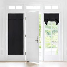 an open white door with black curtains in front of it