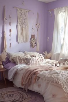 a bedroom with purple walls and lots of hanging items on the wall above the bed