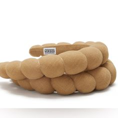 a stack of brown balls sitting on top of each other in front of a white background