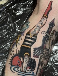 a man's arm with tattoos on it and an image of a bottle in the water