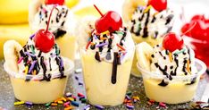 banana split sundaes with cherries and sprinkles on a plate