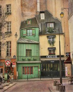 an old building with green shutters and windows