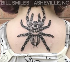 a woman with a spider tattoo on her back