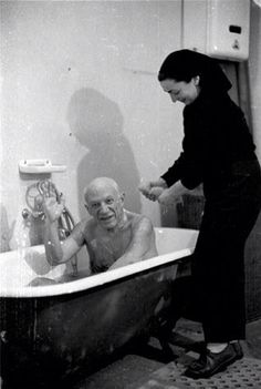 an old man and woman are in the bathtub