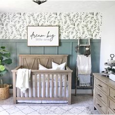 a baby's room with a crib and dresser