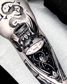 a black and white tattoo with an image of a bottle filled with liquid on the arm