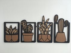 three wooden cutouts with plants in them