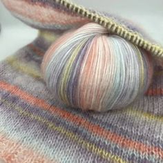 a ball of yarn sitting on top of a blanket