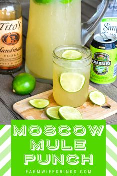 a pitcher of moscow mule punch with limes on the side