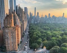 an aerial view of a city with tall buildings and lots of trees in the foreground