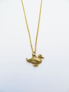 Gold Duck charm necklace. The necklace is made of gold plated steel chain (45cm approx) with detailed gold pewter charm (14mm x 18mm).  It comes in an organza bag ready for gift giving. If you have any questions regarding shipping and payment, please take a look at my shop policies: http://www.etsy.com/uk/shop/LadyMangoJewellery/policy?ref=shopinfo_policies_leftnav ● Shipping: For customers in the UK your order shall arrive within a week though in most cases it's much faster, get in touch if your order is time sensitive and I will do my best to help.  For customers outside the UK, your order can take 1-4 weeks so please leave plenty of time, 80% of orders arrive within 2 weeks.  During Christmas time, please check on our shop announcement for cut-off dates. Duck Jewelry, Duck Necklace, Cruise Jewelry, Tiny Necklace, Jewelry Nature, Sunflower Necklace, Bird Necklace, Bird Pendant, Fan Earrings