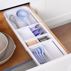 an open drawer with utensils in it