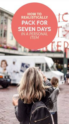 a woman taking a photo with her cell phone in front of a sign that says how to realistically pack for seven days in a personal item