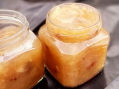 two jars filled with food sitting on top of a table