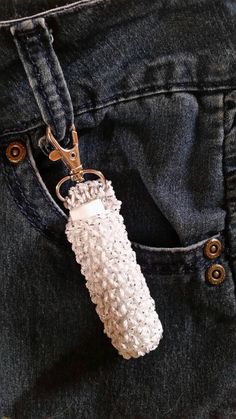 a pair of scissors is in the pocket of a jean pants that has sequins on it