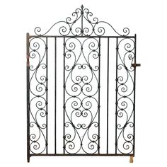 an iron gate with scroll designs on the top and bottom bars, against a white background