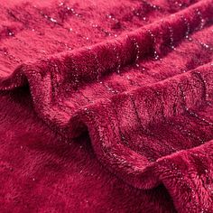 a close up view of a red blanket with sequins on the top and bottom