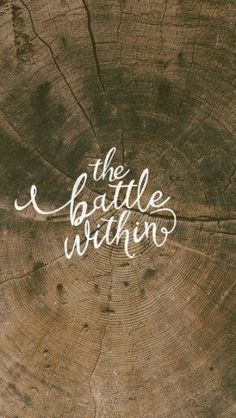 the battle within written on top of a piece of wood with white ink in it