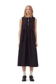 This Cotton Poplin Midi Dress is made from organic cotton. The dress is designed for a relaxed fit with an A-line silhouette and features a round neckline and three tie bands at the front. GANNI Black CottonPoplin Midi Dress in Black | Women's Size 10/12 Black Dress Layered Outfit, Midsummer Dresses, Black Poplin Dress, Artsy Streetwear, Neutral Closet, Front Tie Dress, Black Cotton Dress, Women Wearing Ties, Ganni Dress