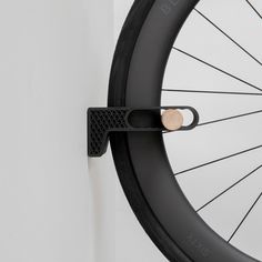 a bicycle tire with a bike wheel on the wall next to it's spokes