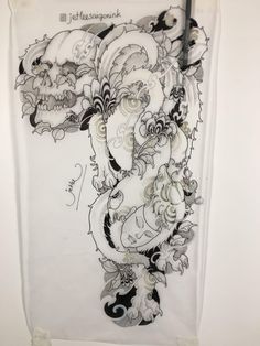 a white wall hanging with some drawings on it