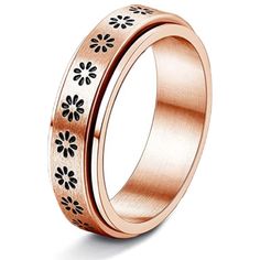 an 18k rose gold wedding ring with black flowers