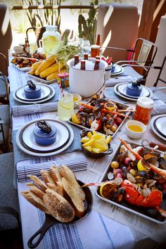 a table set with plates and bowls filled with food