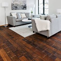 a living room with hardwood floors and white walls