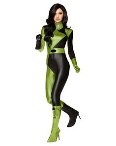 a woman in a green and black catwoman costume is standing with her hands on her hips