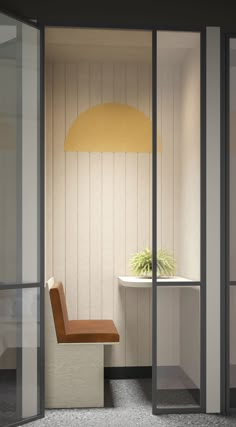 a room with a chair, table and lamp on the wall in front of it