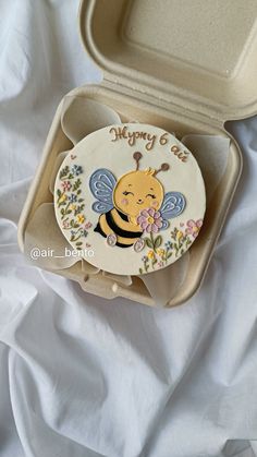 an open box with a bee design on it