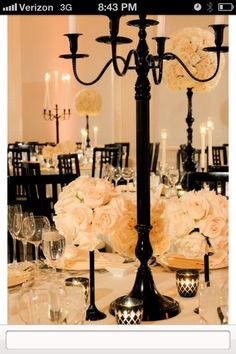 an elegant centerpiece with flowers and candles