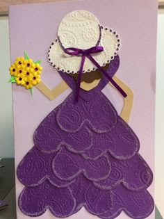 a purple card with an image of a woman in a dress holding a yellow flower