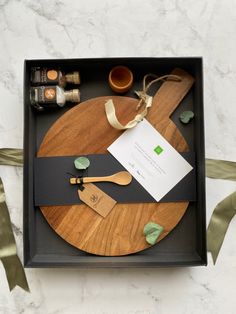 a wooden cutting board sitting on top of a table next to a knife and fork