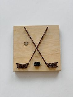 a piece of wood with two sticks sticking out of it