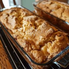 two trays filled with baked goods sitting on top of a stove