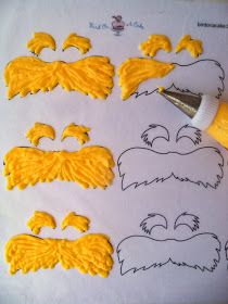 the cookie cutters are made to look like beards and mustaches with yellow icing