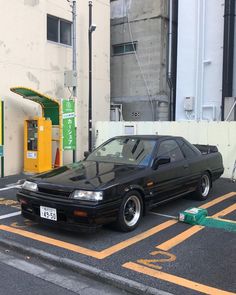 a black car parked in a parking space